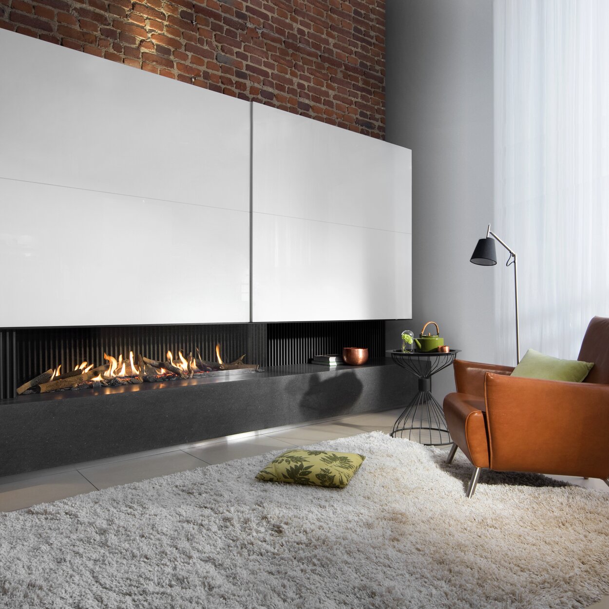 Gas fireplace G165/37C 2-sided glazed on black base unit with white fireplace panelling on brookstone wall
