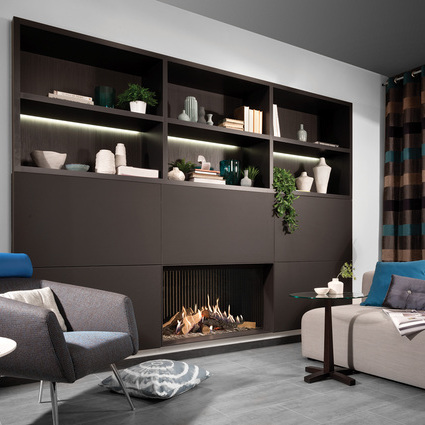 Gas fireplace GP105/59F with front glass built into black wall unit with storage space in the cosy living room