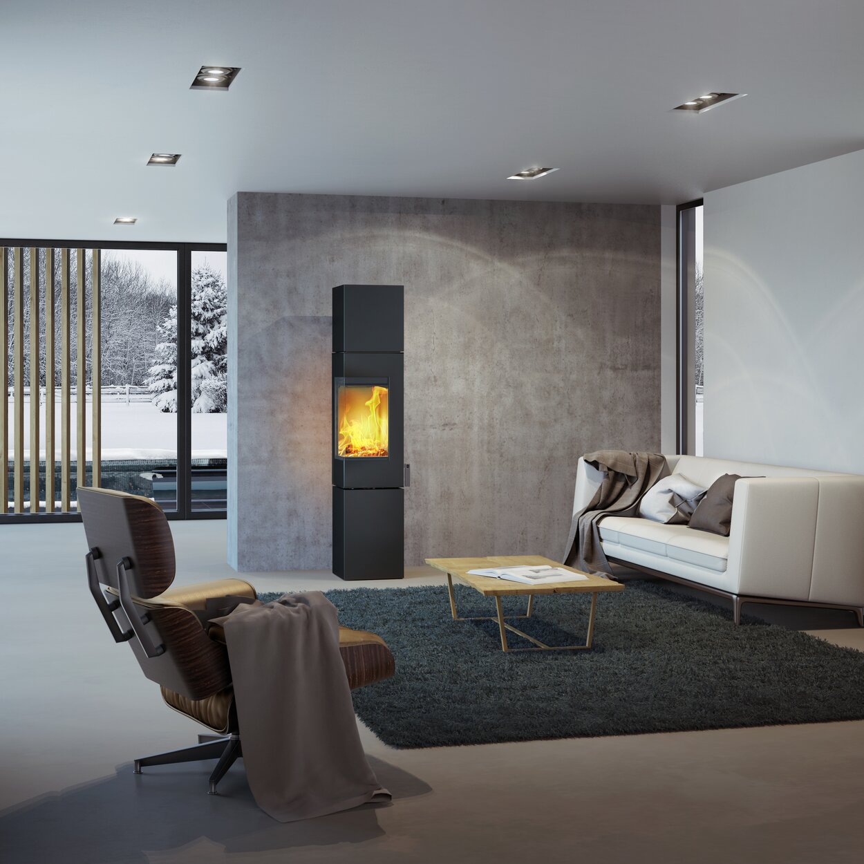 Poêle à bois Q-BE XL en noir avec porte en acier dans un salon moderne entouré d'un beau paysage enneigé